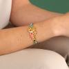 Bracelet ajustable Taratata Bijoux Archipel Métal, résines colorées dont les motifs sont peints à la main, perles en verre, strass, quartz teinté